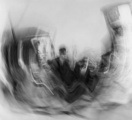 Blurred people next to advertising column