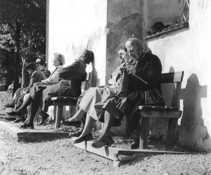 Old ladies on a bench, one is knitting