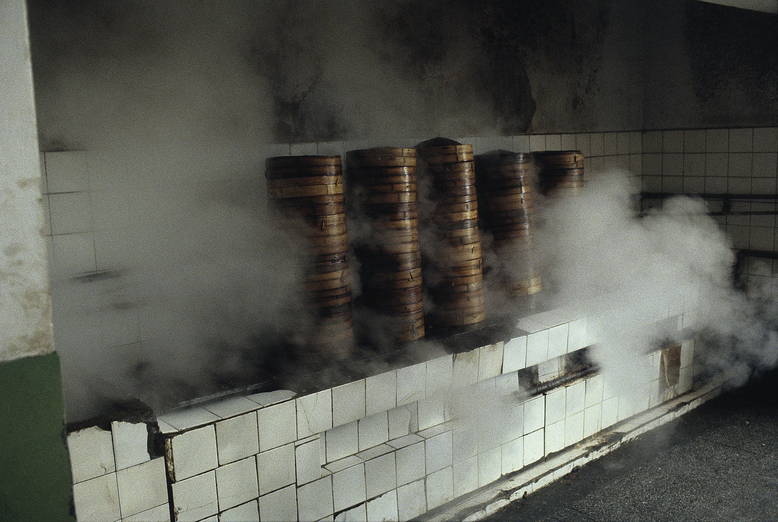 Steaming rice in tall bamboo vessels