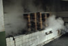 Steaming rice in tall bamboo vessels